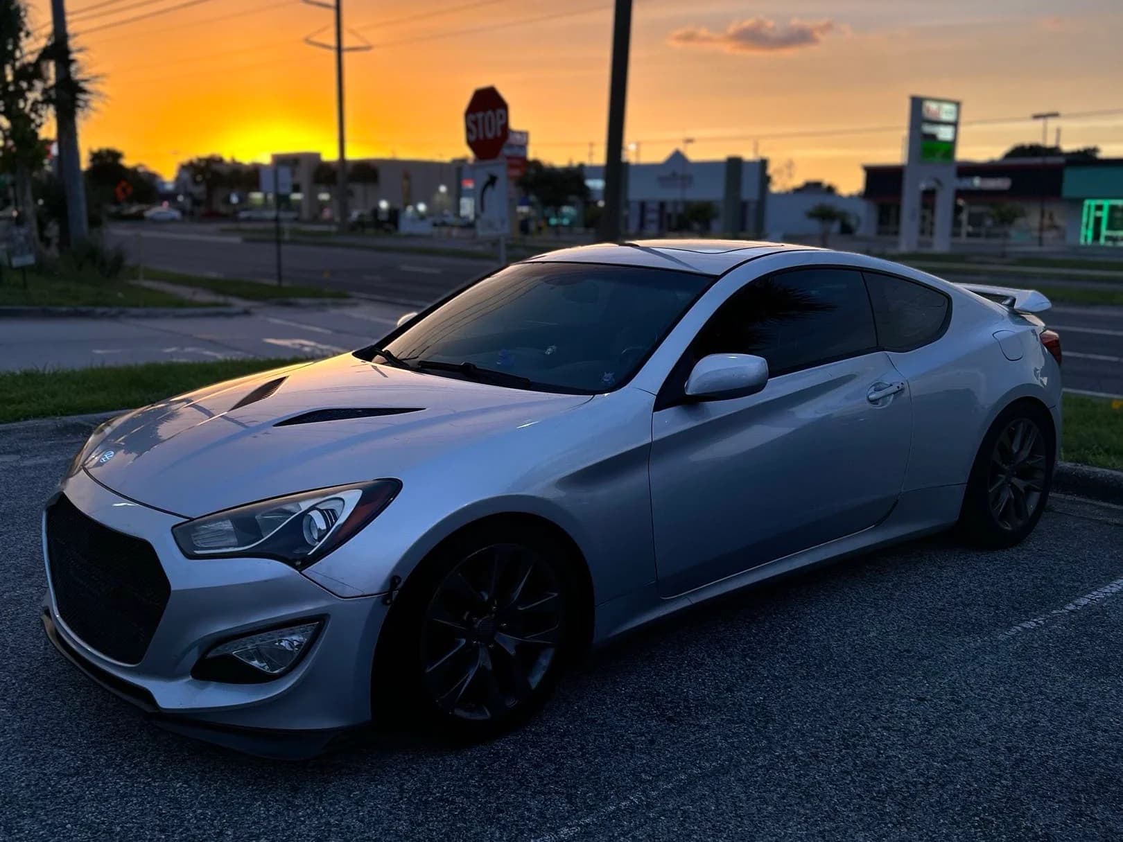 Silver Genesis Coupe at sunset